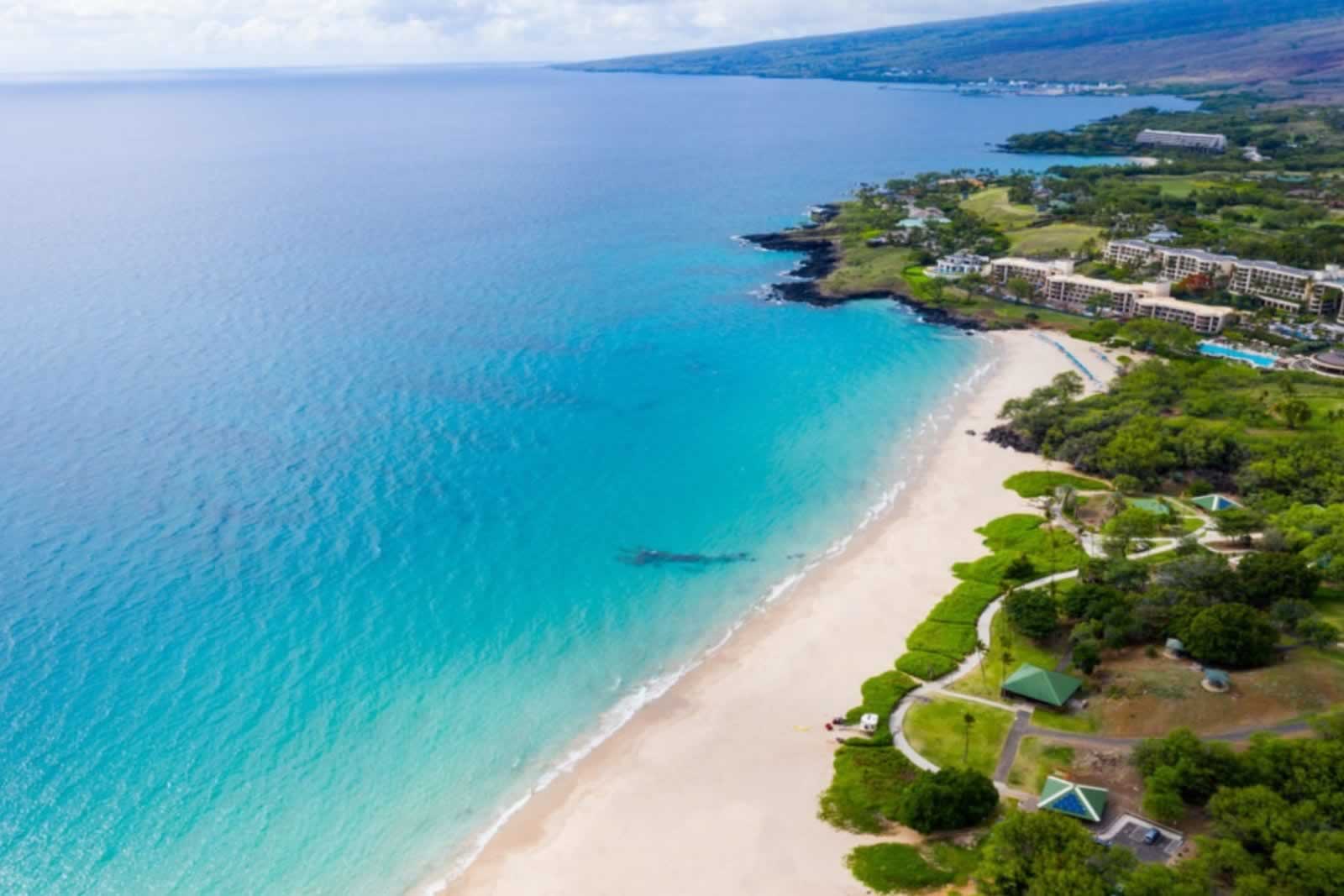 Hapuna Beach State Park with long white sands, turquoise water, and nearby resorts